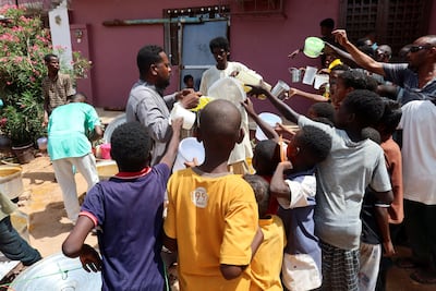 Volunteers distribute food in the city of Omdurman, where many civilians have been caught up in the fighting. Reuters