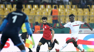 Egypt forward Mohamed Salah runs with the ball under pressure from Sudan's defender Mazin Mohamedein Alnour Mohamed. AFP