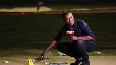A reporter on the crime scene in Tel Aviv. One man was killed and five people were wounded in the attack. AFP