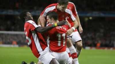 Arsenal's Robin van Persie, center, celebrates after scoring the Gunners' third goal in a 4-0 win against Group G opponents FC Porto.