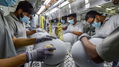 Others polish and paint the exterior of the helmets before packing them for export to more than 80 countries worldwide