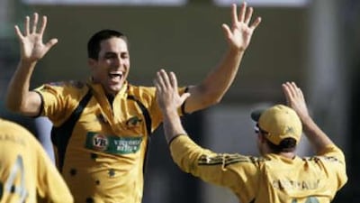 The Australia bowler Mitchell Johnson, left, celebrates with teammate Mike Hussey after taking his last wicket.