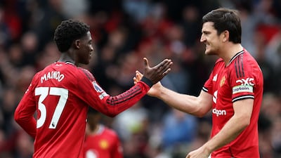 Kobbie Mainoo and Harry Maguire celebrate Manchester United's win over Liverpool at Old Trafford. AFP