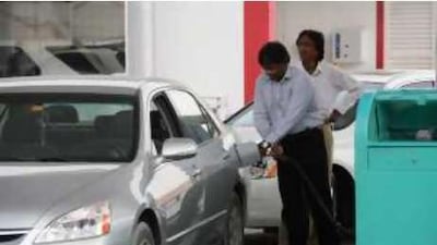 A customer filling up with petrol at an Enoc station off Jumeirah Beach Road in Dubai. The self-service pilot scheme has been discontinued.