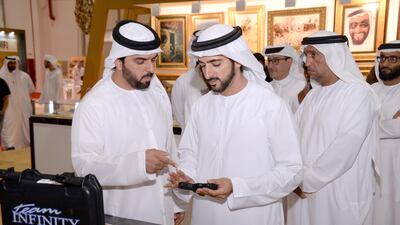 Sheikh Hamdan bin Mohammed, Crown Prince of Dubai, is shown hunting equipment during his tour of Adihex on Friday. Wam