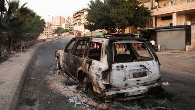 A burnt car is seen after an ambush on a Hezbollah funeral procession in Khalde, Lebanon.