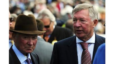 Veteran horse trainer Barry Hills, left, shown here with Manchester United manager Sir Alex Ferguson, will manage 14 horses in Lambourn. John Giles / PA
