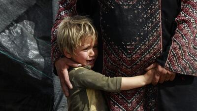 Five years old Palestinian boy Ahmad Tubasi cries after he and his family arrive to inspect the remains of their demolished agricultural storehouses in the are around Al-Jeftlik in the northern Jordan Valley, east of Nablus, West Bank. Alaa Badarneh / EPA