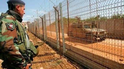 Lebanese soldiers stare down an Israeli army patrol near the Lebanese village of Kfarkilla.
