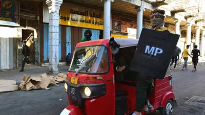Protesters ride a Tuk-tuk during protests in the Rasheed street. EPA