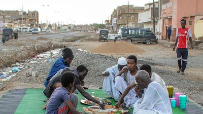 People gather for a meal to break their fast during Ramadan in Port Sudan. AFP