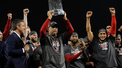 Boston Red Sox manager Alex Cora hoists the Commissioner's Trophy. Reuters