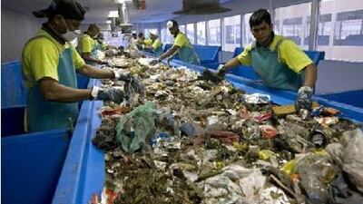 Separators look for aluminium, plastic, paper and cardboard at the Sharjah landfill.