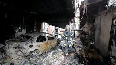 French firemen inspect damage inside a leisure centre after overnight clashes where gangs of youths set cars and buildings ablaze in Amiens.
