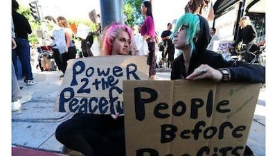As anti-corporate protesters, like those pictured here, gather across the United States, one reader argues that voters in the US should heed these messages and push for greater corporate responsibility. AFP / Frederic J Brown