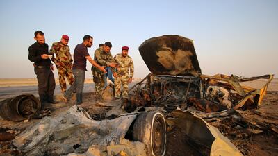 Iraqi security forces inspect the site of a bomb attack at a police checkpoint on a highway near the southern Iraqi city of Nassiriya, Iraq, on September 14, 2017. Essam Al Sudani / Reuters