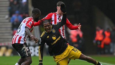 Manchester United's Patrick Dorgu is challenged by Sunderland's Trai Hume. AFP