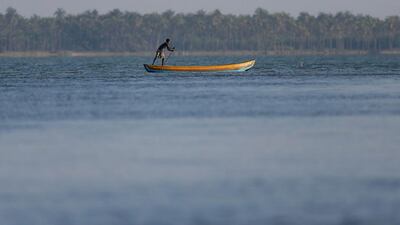 A man paddles along a lagoon in Kalpitiya, Sri Lanka. Dinuka Liyanawatte / Reuters