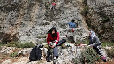 A group of Palestinians climb near the village of Yabrud, just north of Ramallah. Abbas Momani / AFP