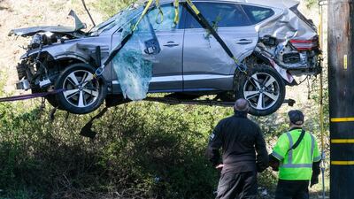A crane is used to lift the SUV crashed by Tiger Woods in Los Angeles in February. AP