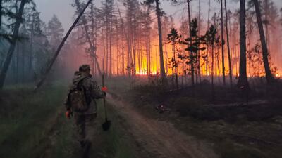 A volunteer heads to fight a forest fire in Yakutia, in Russia's Far East, on July 17. AP