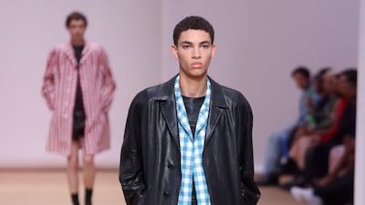 Lightweight gingham coats worn under leather jackets at Prada spring/summer 2023. Photo: EPA