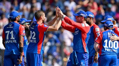 Delhi Capitals' Anrich Nortje celebrates with teammates after taking the wicket of Mumbai Indians' Suryakumar Yadav for a duck. AFP