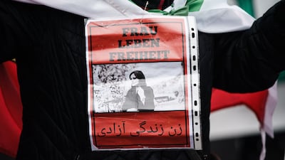 A protester carries a portrait of Mahsa Amini during an anti-Iran protest in Berlin, Germany. EPA