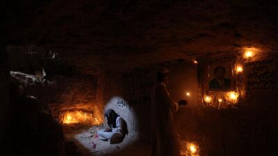 A man reads verses from the Koran at the grave of his relative at the Wadi al-Salam cemetery, Arabic for "Peace Valley", in Najaf, south of Baghdad, Iraq. Alaa Al-Marjani / Reuters