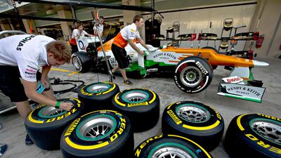 Force India's pit crew wheel driver Nico Hulkenberg's car to the scrutineering garage at Yas Marina Circuit. Christopher Pike / The National