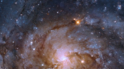 The Hubble telescope took a picture of a galaxy hidden behind the Milky Way. The spiral galaxy, IC 342, is about 11 million light years from Earth. Photo: Nasa / European Space Agency