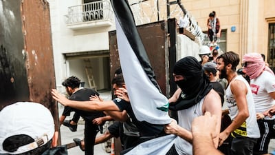 Demonstrators force their way past barricades around the Lebanese parliament during French President Emmanuel Macron's visit to Beirut on September 1, 2020. Karine Pierre / Hans Lucas