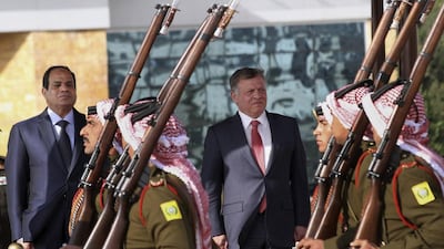 Jordan's King Abdullah II and Egyptian President Abdel Fattah El Sissi review an honor guard at Marka airport in Amman on December 11. Raad Adayleh / AP Photo