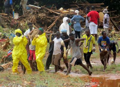 Rescue workers carry a victim from the site of a mudslide in Regent, east of Freetown, Sierra Leone on August 14, 2017. Manika Kamara/AP Photo