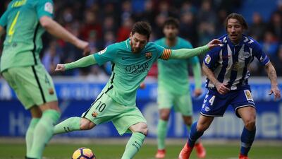 Lionel Messi, left, competes for the ball with Alexis Ruano of Alaves. Gonzalo Arroyo Moreno / Getty Images
