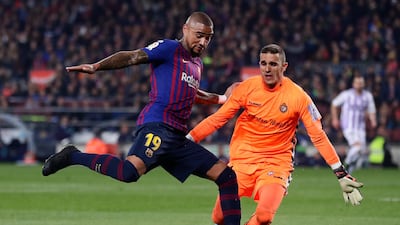 Barcelona's Kevin-Prince Boateng duels for the ball with Real Valladolid's Jordi Masip. AP Photo