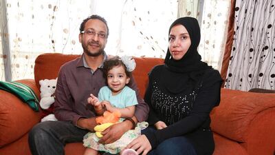 Two-year-old Fatima with her mother and father. The toddler is in need of medical treatment in Germany to correct an allergic reaction to food. Victor Besa for The National
