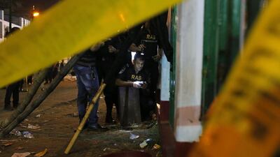 A Bangladeshi bomb disposal unit from Rapid Action Battalion (RAB) defuse an unexploded bomb at the site of an explosion that killed at least one person in Dhaka on October 24. AP