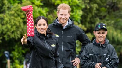 Meghan, Duchess of Sussex participates in a gumboot throwing competition with Prince Harry in Auckland, New Zealand, in October 2018. AFP