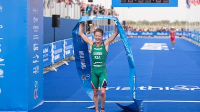 Henri Schoeman raises the finishing tape after winning the ITU World Triathlon Abu Dhabi. Reem Mohammed / The National