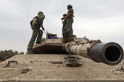 Israeli army soldiers are positioned with their Merkava tanks near the border with the Gaza Strip. AFP