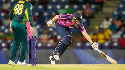 Scotland captain Richie Berrington reaches out to make his ground. AP