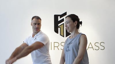 Abu Dhabi resident Metaxia Kladis gets fitness guidance from Hayden Thin, director fitness consultant at Fit First Class at The Beach Club, Khalidiya Palace Rayhaan. Ravindranath K / The National