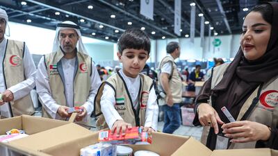 Preparing relief goods for Lebanon, at Adnec. Victor Besa / The National