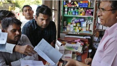 An Indian pharmacist receives prescriptions to prepare medicines at his store in Allahabad. The ruling means poor patients around the world will get continued access to cheap versions of lifesaving medicines.