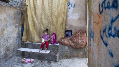Nur Abu Sneineh sits outside her home squeezing at the entrance of her family's home on September 27, 2015, in the impoverished overpopulated lower income Batin Al Hawa section of East Jerusalem's Silwan neighborhood, as Jewish settlers take over the rest of the building she lives in. Heidi Levine for The National