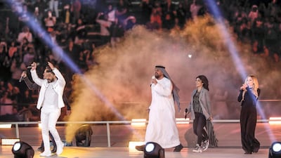 Hussain Al Jassmi, centre, Assala and Avril Lavigne, right, and left Luis Fonsi and Tamer Hosny as they performed Special Olympics anthem Right Where I'm Supposed To Be at the World Games Abu Dhabi 2019 on Thursday night. Antonie Robertson / The National