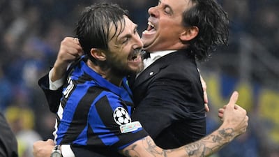 Inter's head coach Simone Inzaghi, right, celebrates with defender Francesco Acerbi after victory over Barcelona in the semi-finals of the Champions League. EPA
