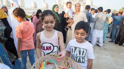 Worshippers celebrate Eid Al Fitr outside Sheikh Zayed Mosque early on Tuesday morning.
