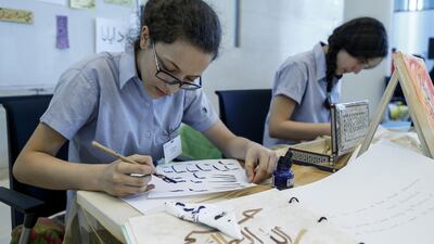 Students from the Dubai International Academy practice Arabic calligraphy at the KHDA conference. Antonie Robertson / The National